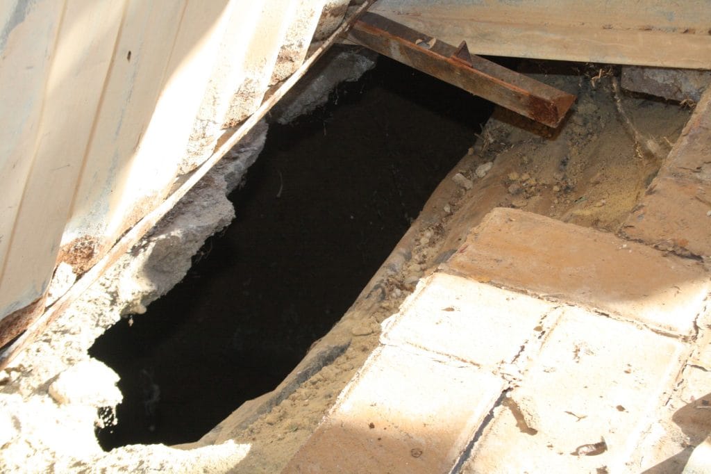 The hole in the ground which leads to a dark deep sinkhole underneath. Photo by Sonqoba Kunene