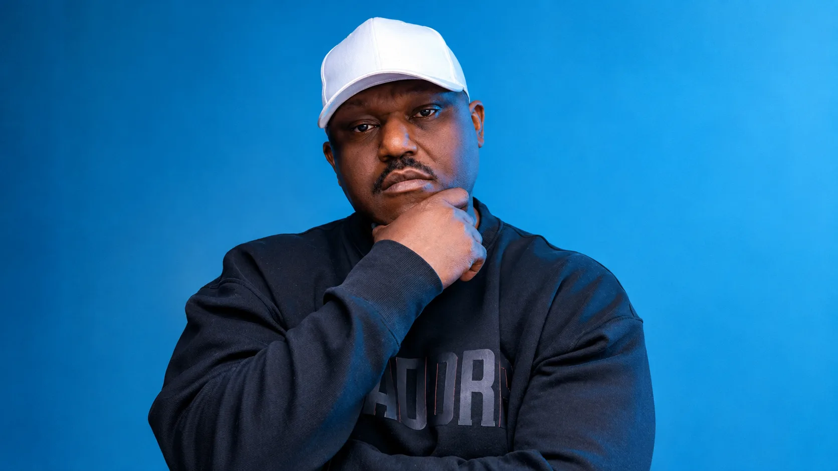 Thoughtful Portrait Against Blue Backdrop